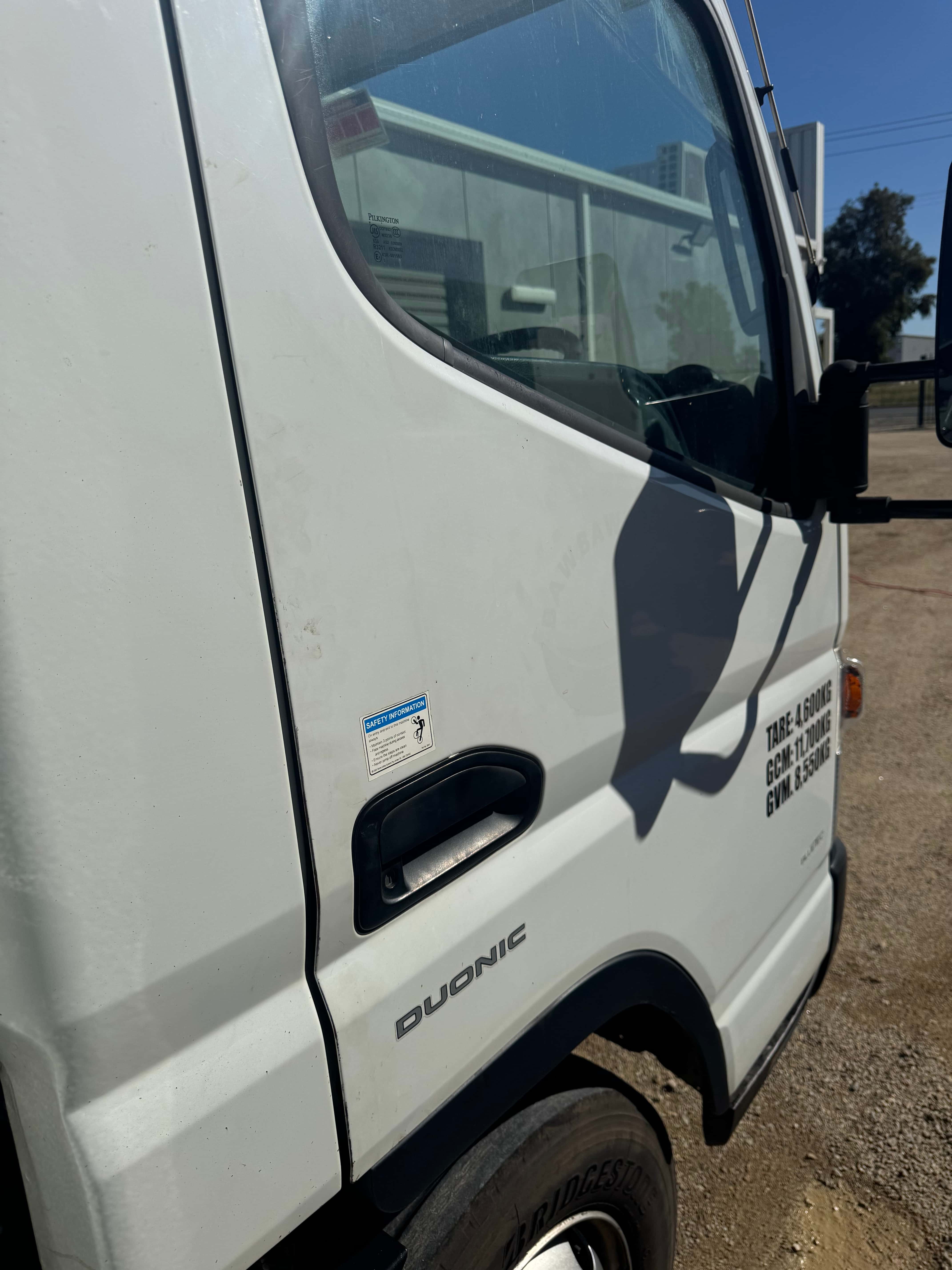 Work truck passenger side before detailing by Domma's Detailing